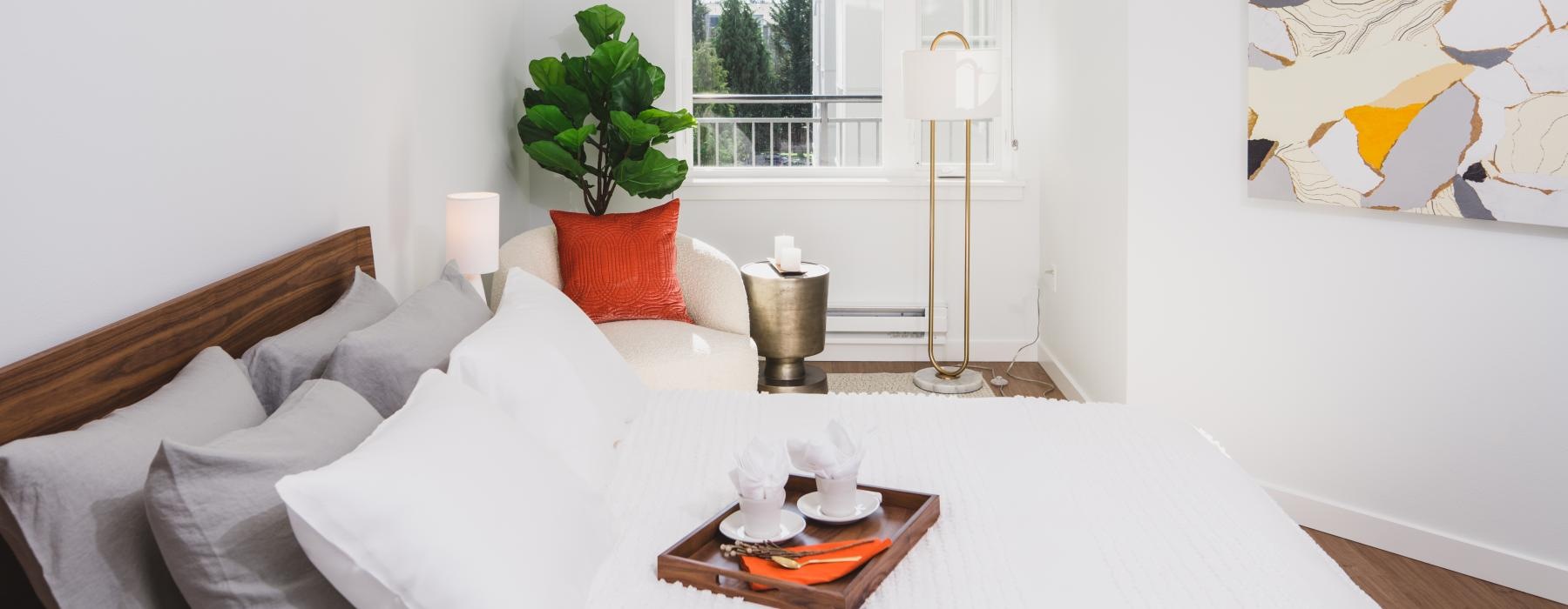 a bedroom with a white bed and a window