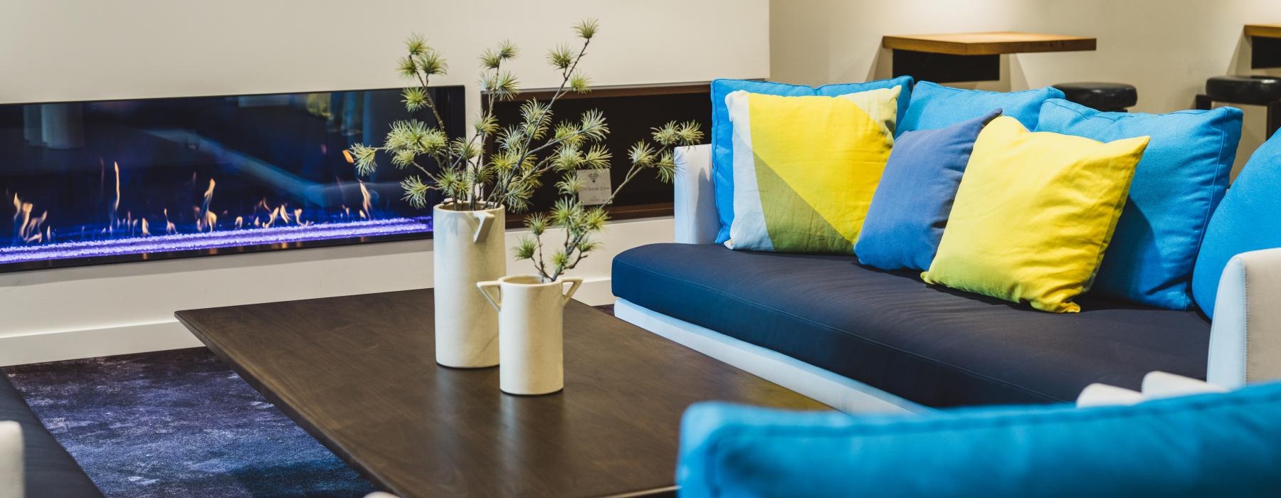 a living room with blue couches